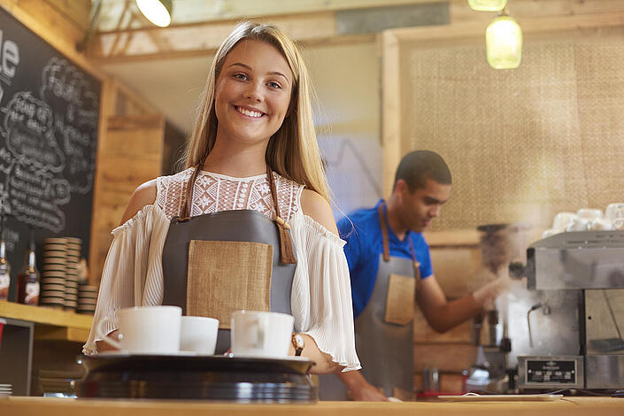 Junge Frau arbeitet in einem Kaffee.